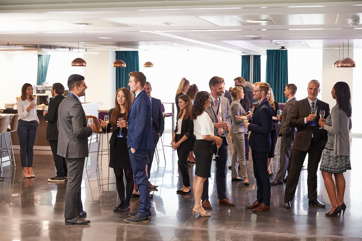 Guests networking with drinks at a business event