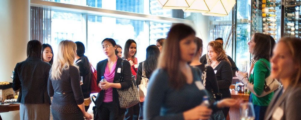 Professionals talking at a networking event